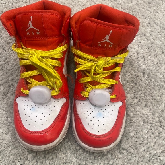 Nike Air Jordans in a red/orange color with after market yellow